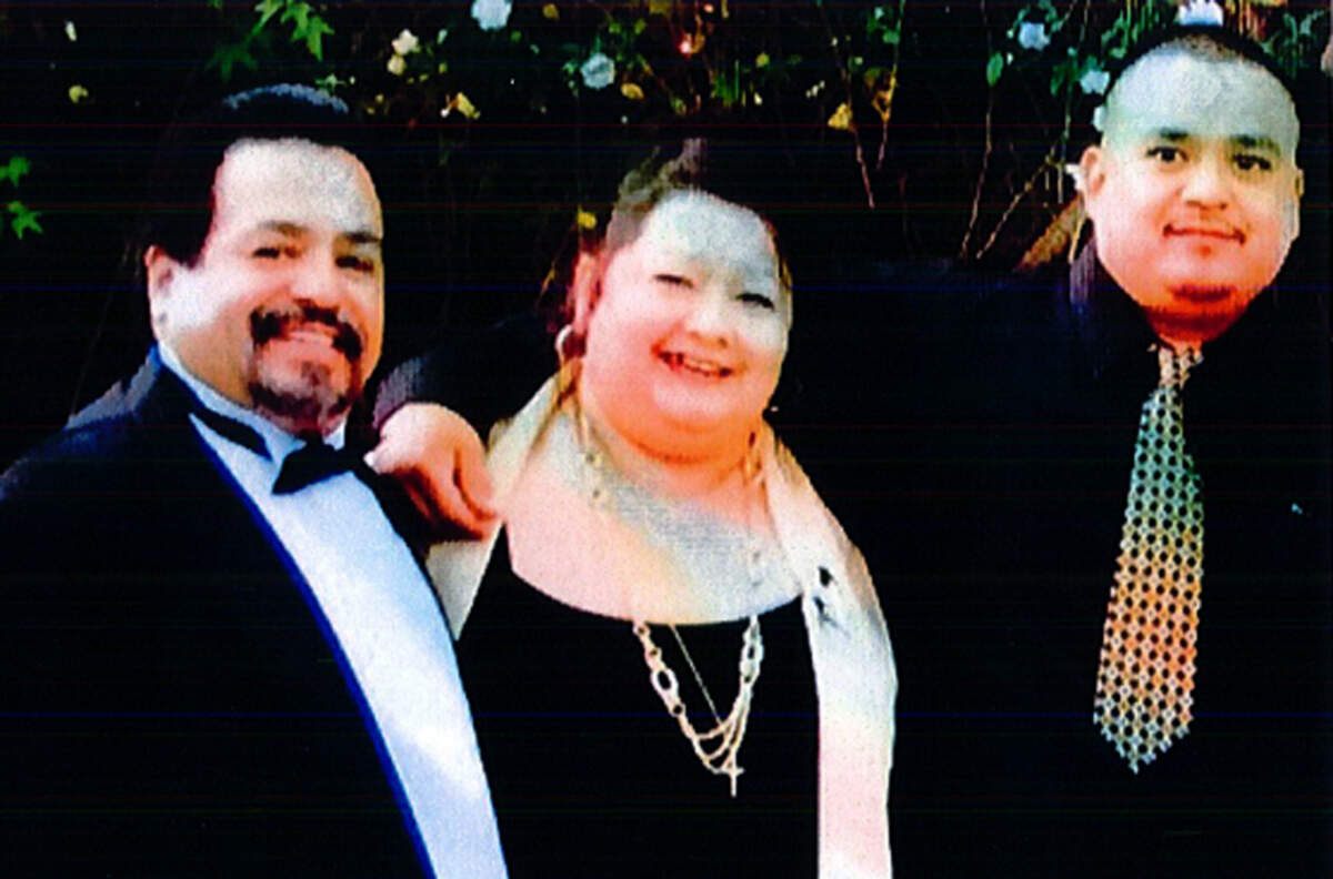 In this undated picture, Fresno residents Anthony and Cecilia Perez stand with their son, Joseph Perez, for a photograph. The Perez family has sued the city of Fresno and Fresno County in federal court for wrongful death, accusing police and sheriff's deputies of killing Joseph Perez in May 2017. A coroner's report says Perez, 41, had methamphetamine in his body but died of "compression  asphyxia during restraint" and said his death was the result of a homicide.